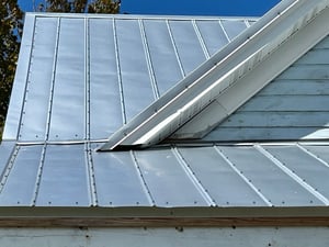 5V crimp  metal roof showing exposed screws