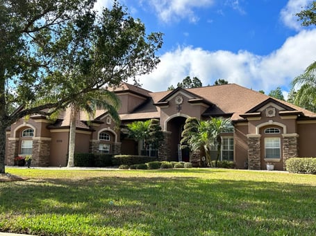 Beautiful stucco with cultured stone accents with gAf shakewood shingles