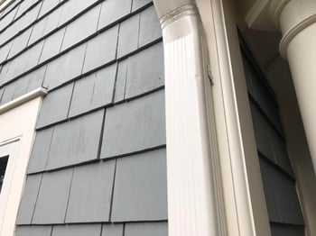 Gutter downspout with hail damage