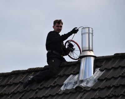 homeowner doing a roof repair on a vent