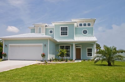 white standing metal roof on a sea foam color house