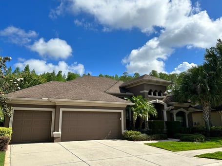 Stucco home with GAF barkwood shingles