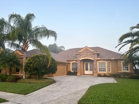 Stucco home with cultured stone accent and GAF Shakewood shingles