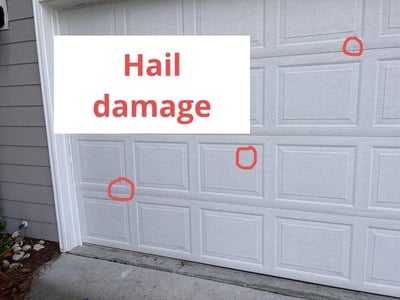 Double car garage door with hail damage