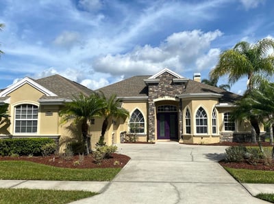 Florida-style stucco home with new asphalt shingles