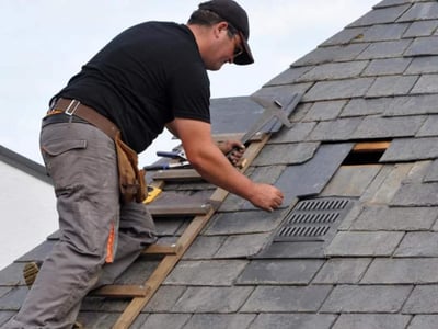 roofer replacing slate shingles
