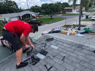 roofer repairing a 3-tab shingle roof in Tampa