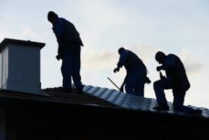 Roofer Silhouettes on Roof