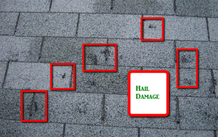 Red boxes around hail impacts on an asphalt shingle