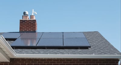 rack mounted solar panels on an asphalt roof