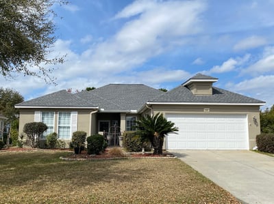 stucco home with architectural shingles