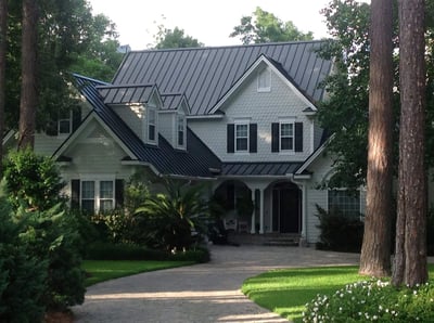 black metal standing seam roof on a beautiful home with lots of Georgia pine trees