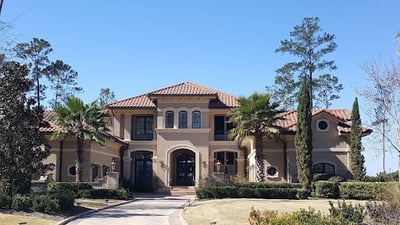 Stucco home with concrete tile hip roof