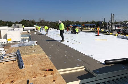 commercial crew installing a new TPO flat roof system