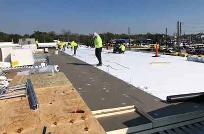 crew installing commercial flat roof
