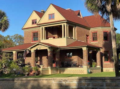 Victorian-style home with red designer shingles