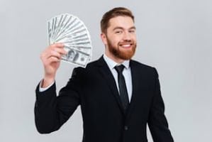 graphicstock-happy-bearded-business-man-in-black-suit-holding-money-in-hand-and-looking-at-camera-isolated-gray-background_SUxg1ruX_ng-300x201