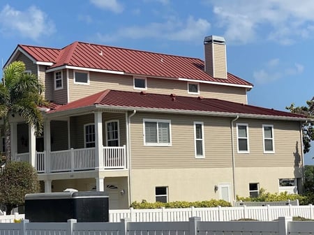 large home with red standing seam metal roof