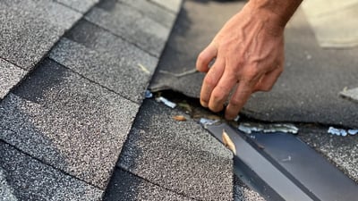 loose cracking shingles in a metal valley
