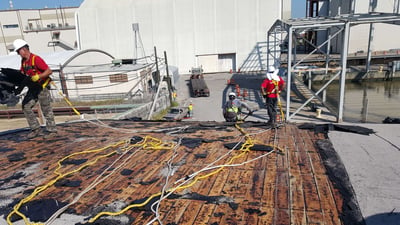 crew removing a mod-bit roof