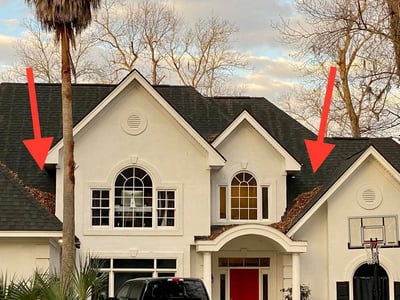 poor roof maintenance shown on a beautiful home