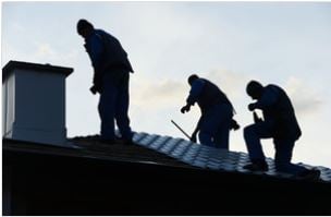 Three Roofers completing roofing project