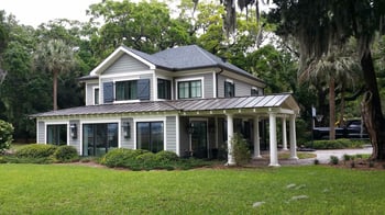 beautiful split-level home with shingles and metal roofing