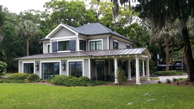 beautiful split-level home with shingles and metal roofing