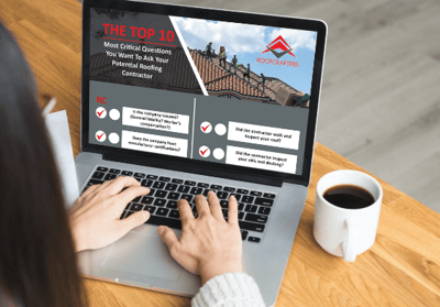 someone using a computer looking at Roofcrafters top 10 roof replacement checklist

