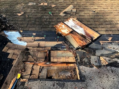 mold and rotten plywood damage at a valley transition of a roof