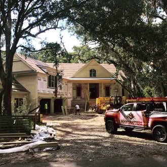 new home under construction with RoofCrafters truck out front
