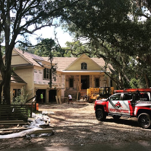 New house under construction-RoofCrafters truck