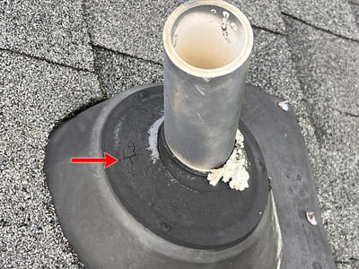 old plastic pipe flashing with dry rotted gasket around the pipe