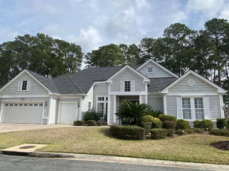 White custome home with black architectural shingle roof
