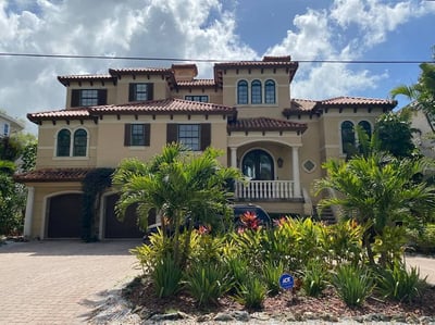 large home with tile roof that has multiple valleys