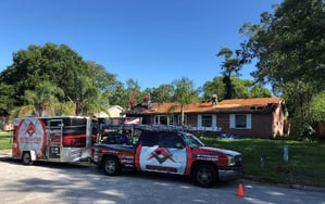 RoofCrafters Truck and Trailer in front of a shingle roof replacement