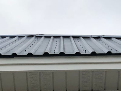 Screws backing out an exposed fastener blue metal roof