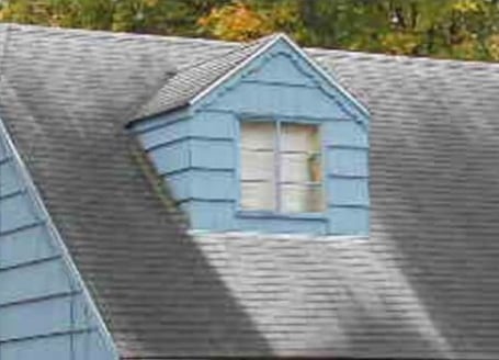 Shingle roof with black algae streaks