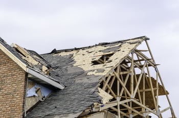 Skeletal remains of peaked roof on house hit by tornado