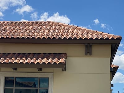 Upper hip roof and a small lean-to with Spanish clay tiles