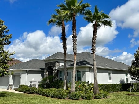 Stucco home with cultured stone and GAF charcoal shingles