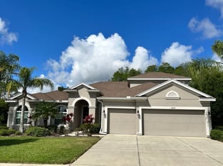 Stucco home with hip and gable roof with shingle roof