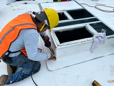roofer welding TPO on a hvac curb