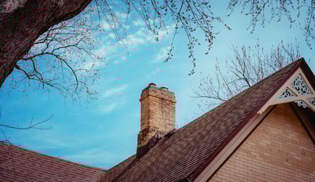 brown toned home with brick chimney