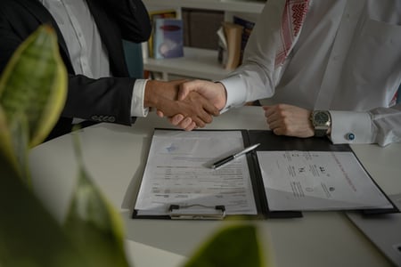 men signing document