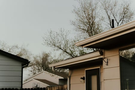beige house with gutters