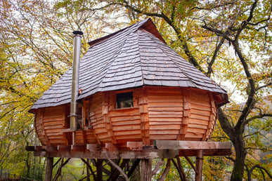 unique treehouse with wood shingles