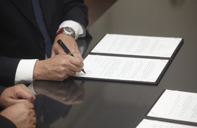 close up of businessman hands signing an estimate