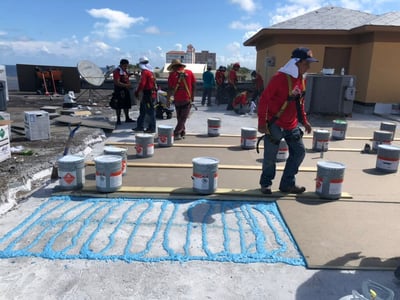 RoofCrafters crew installing fully adhered TPO roof system