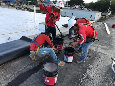 roofing crew doing flat roof repairs